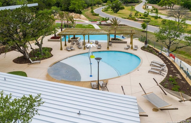 pool with a patio, fence, and a pergola