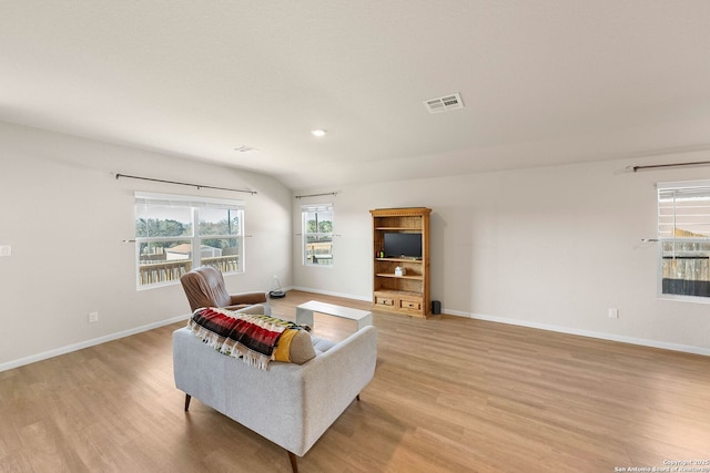 living area with visible vents, baseboards, and light wood-style flooring