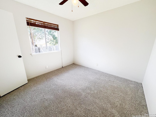 empty room with carpet flooring and a ceiling fan