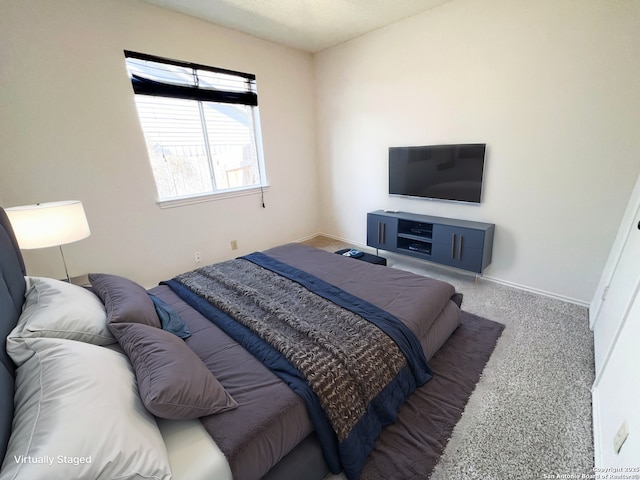 carpeted bedroom with baseboards