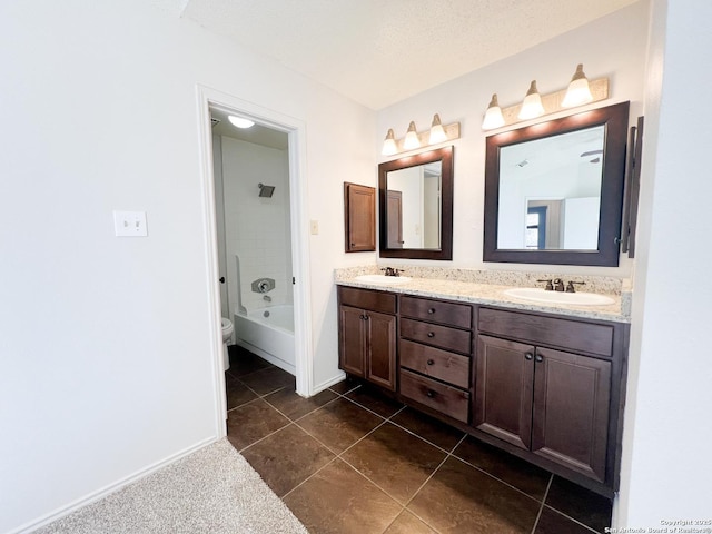 bathroom featuring a sink, a tub, double vanity, and tile patterned flooring