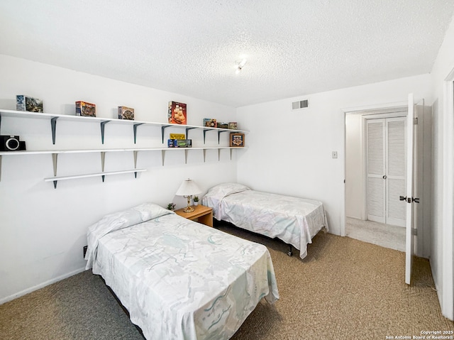 carpeted bedroom featuring visible vents and a textured ceiling