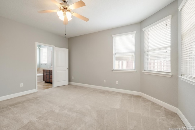 12535 Quarter J, San Antonio, TX 78254 - unfurnished bedroom with multiple windows, baseboards, and light carpet