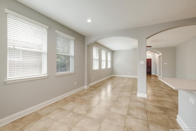 12535 Quarter J, San Antonio, TX 78254 - unfurnished room featuring baseboards, light tile patterned floors, recessed lighting, arched walkways, and a ceiling fan