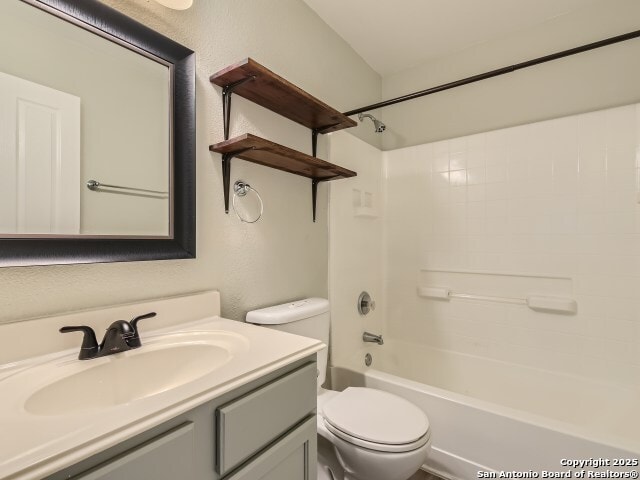 full bath with toilet, shower / washtub combination, and vanity