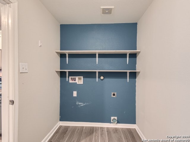 clothes washing area featuring wood finished floors, visible vents, laundry area, electric dryer hookup, and washer hookup