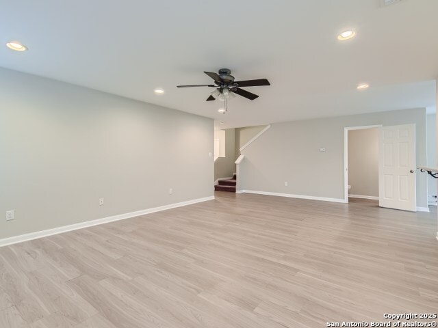 unfurnished room featuring stairs, recessed lighting, baseboards, and ceiling fan