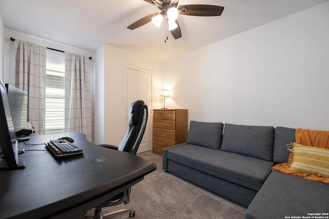 carpeted home office with a ceiling fan