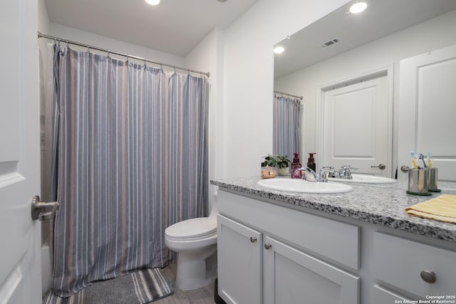 full bath with vanity, toilet, recessed lighting, and visible vents