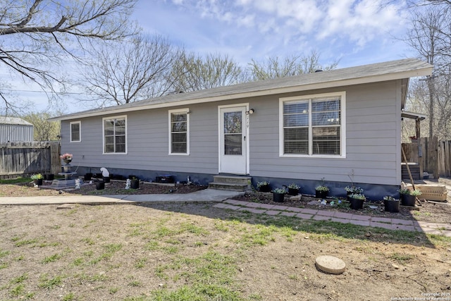 view of front of house with fence, a front yard, and entry steps