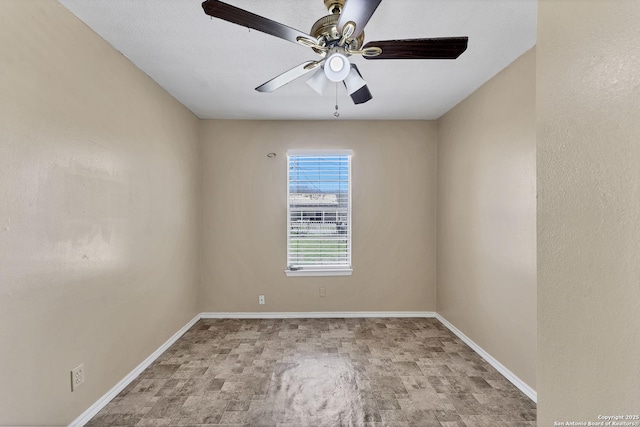 unfurnished room featuring baseboards and a ceiling fan