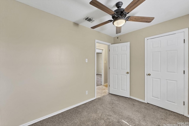 unfurnished bedroom featuring a ceiling fan, carpet flooring, visible vents, and baseboards