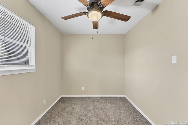 unfurnished room with visible vents, baseboards, carpet, and ceiling fan