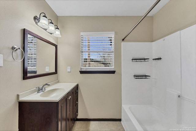 full bathroom featuring vanity, baseboards, and shower / bathtub combination