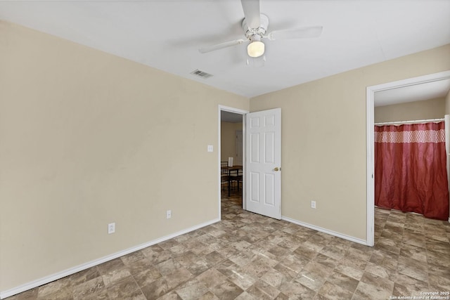 unfurnished bedroom with baseboards, visible vents, and ceiling fan