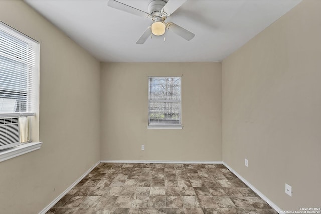 empty room featuring baseboards and ceiling fan