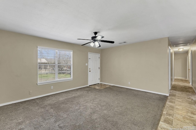 interior space featuring visible vents, baseboards, and ceiling fan