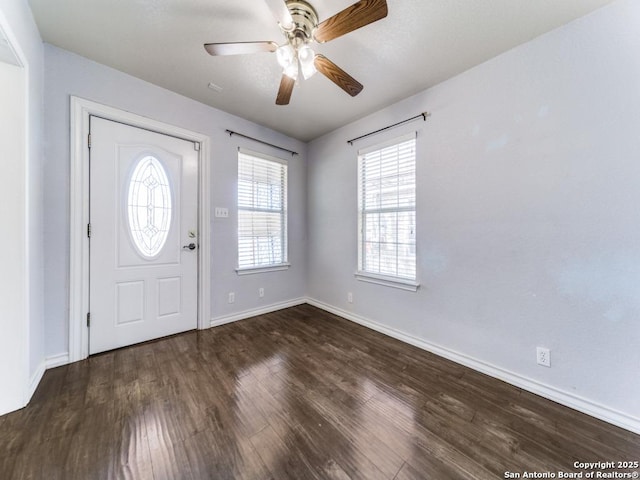 foyer with baseboards, ceiling fan, and wood finished floors