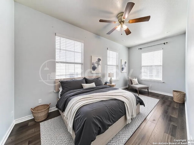 bedroom with a ceiling fan, baseboards, and wood finished floors