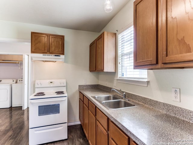 kitchen with under cabinet range hood, washing machine and dryer, electric stove, brown cabinetry, and a sink