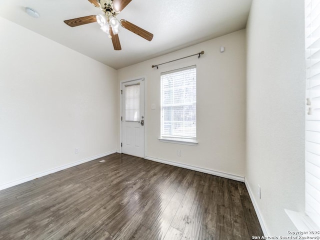 spare room with a ceiling fan, wood finished floors, and baseboards