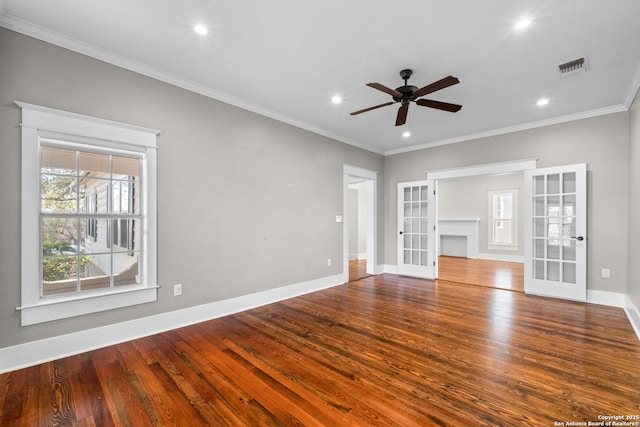 unfurnished living room with a ceiling fan, wood finished floors, french doors, crown molding, and baseboards