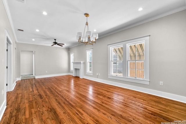 unfurnished living room with wood finished floors, visible vents, baseboards, recessed lighting, and crown molding