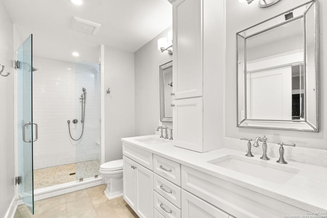 bathroom with a shower stall, toilet, double vanity, and a sink