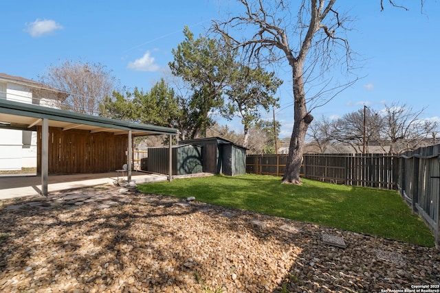 view of yard featuring an outdoor structure, a storage unit, and a fenced backyard