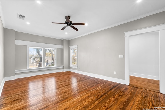 unfurnished room featuring visible vents, baseboards, ceiling fan, ornamental molding, and wood finished floors