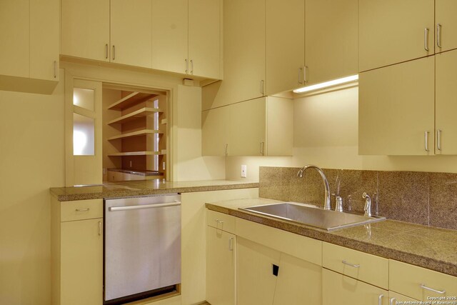 kitchen with tile countertops, dishwasher, and a sink