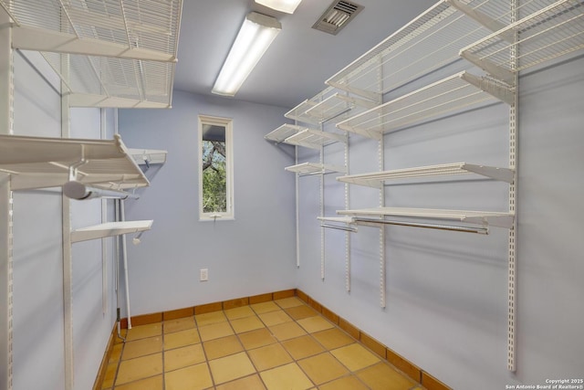 walk in closet with light tile patterned flooring and visible vents