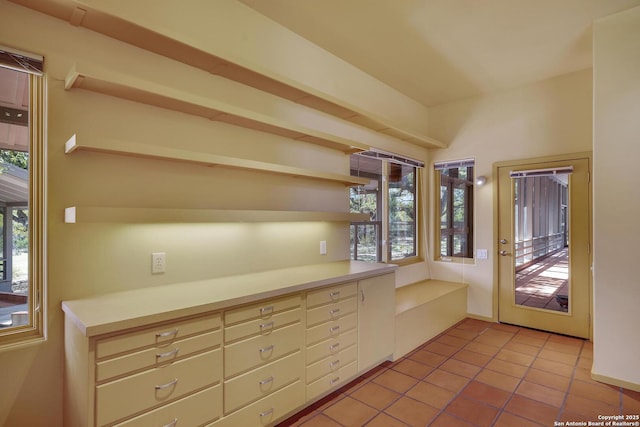 kitchen featuring open shelves, light countertops, and light tile patterned floors