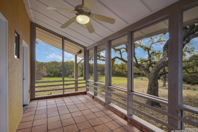 unfurnished sunroom featuring ceiling fan