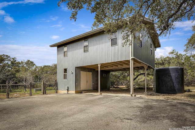 view of front of house with aphalt driveway, a gate, and a carport