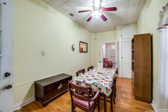 dining area featuring a ceiling fan, visible vents, and light wood finished floors