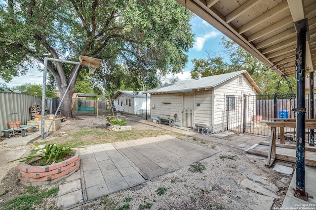 view of patio / terrace with a fenced backyard and an outdoor structure