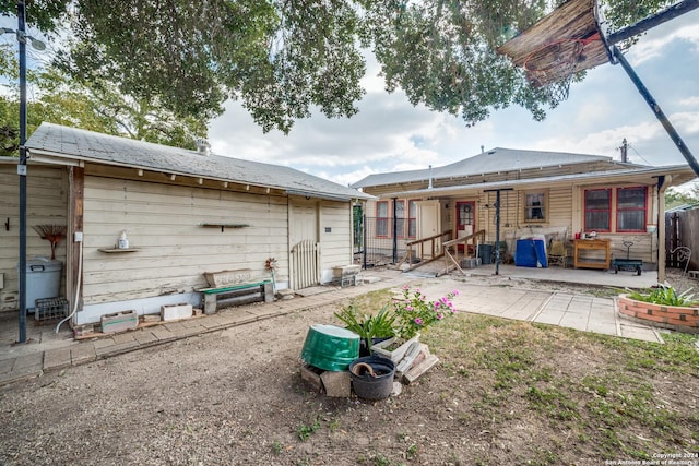 rear view of house featuring a patio and fence