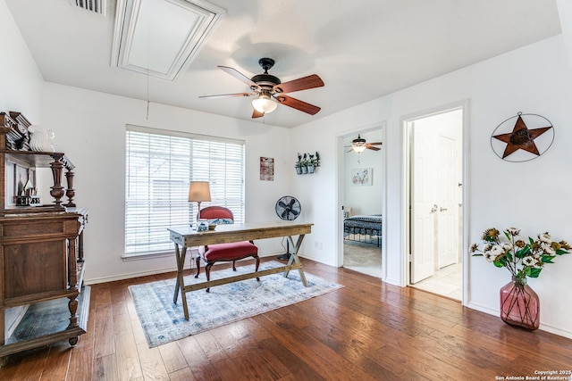 office space featuring baseboards, attic access, ceiling fan, and hardwood / wood-style floors