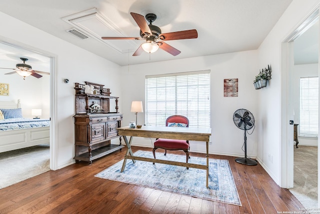 office area with attic access, dark wood-style floors, visible vents, and ceiling fan