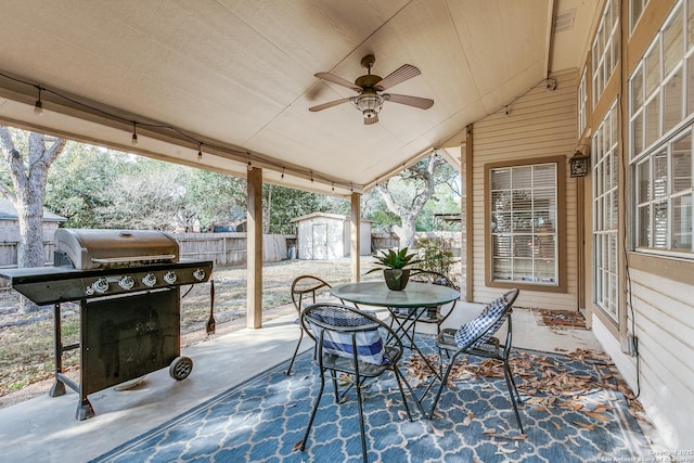 view of patio featuring outdoor dining space, an outbuilding, a fenced backyard, grilling area, and a storage shed