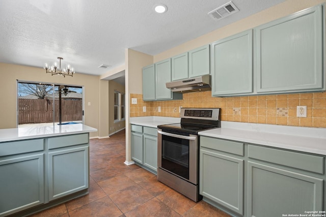 1967 Club Xing, New Braunfels, TX 78130 - kitchen with stainless steel electric range oven, visible vents, under cabinet range hood, a notable chandelier, and tasteful backsplash