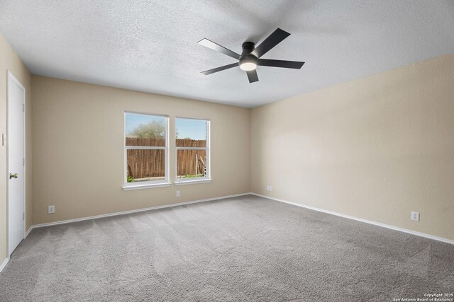 1967 Club Xing, New Braunfels, TX 78130 - spare room featuring baseboards, carpet, ceiling fan, and a textured ceiling