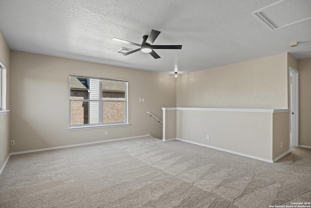1967 Club Xing, New Braunfels, TX 78130 - carpeted spare room with visible vents, baseboards, ceiling fan, attic access, and a textured ceiling