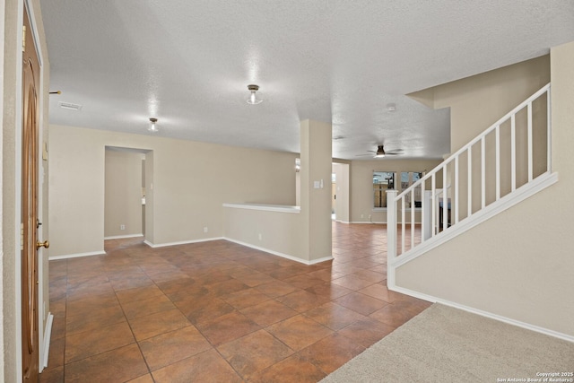 1967 Club Xing, New Braunfels, TX 78130 - interior space with visible vents, dark tile patterned flooring, a textured ceiling, stairway, and baseboards