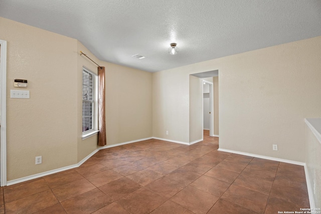 1967 Club Xing, New Braunfels, TX 78130 - empty room with tile patterned flooring, a textured ceiling, and baseboards