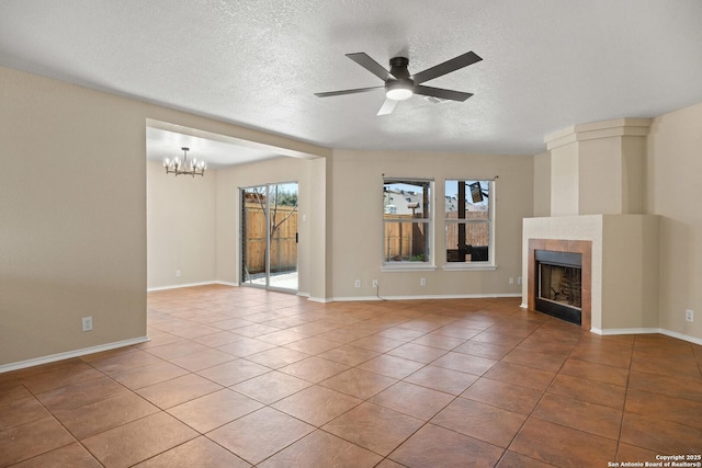 1967 Club Xing, New Braunfels, TX 78130 - unfurnished living room with plenty of natural light, ceiling fan with notable chandelier, a fireplace, and tile patterned flooring