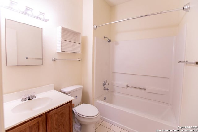 bathroom featuring tile patterned floors, toilet, vanity, and washtub / shower combination