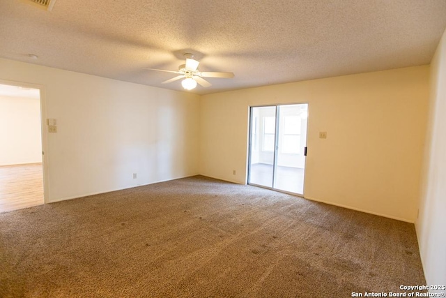 unfurnished room with a ceiling fan, carpet floors, and a textured ceiling