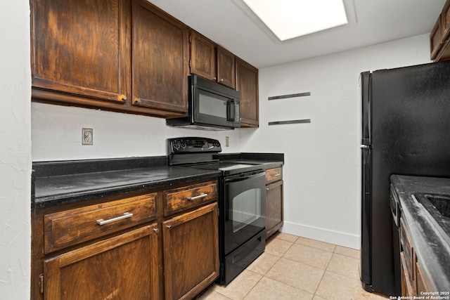 kitchen with black appliances, light tile patterned floors, baseboards, and dark brown cabinets